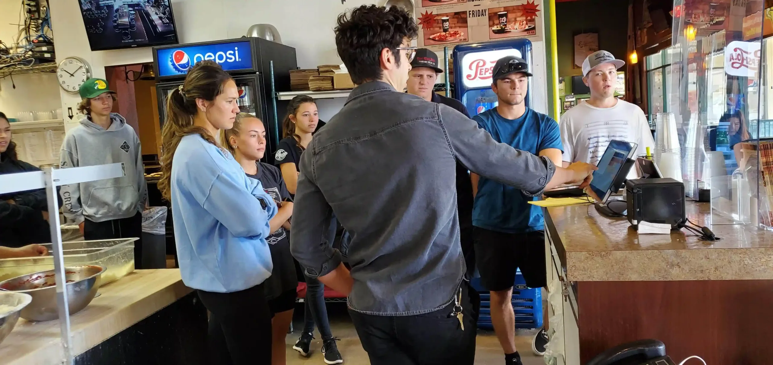 Sora Partners ensures a smooth transition: Technician trains employees on a new POS system after successful installation (providing ongoing support).