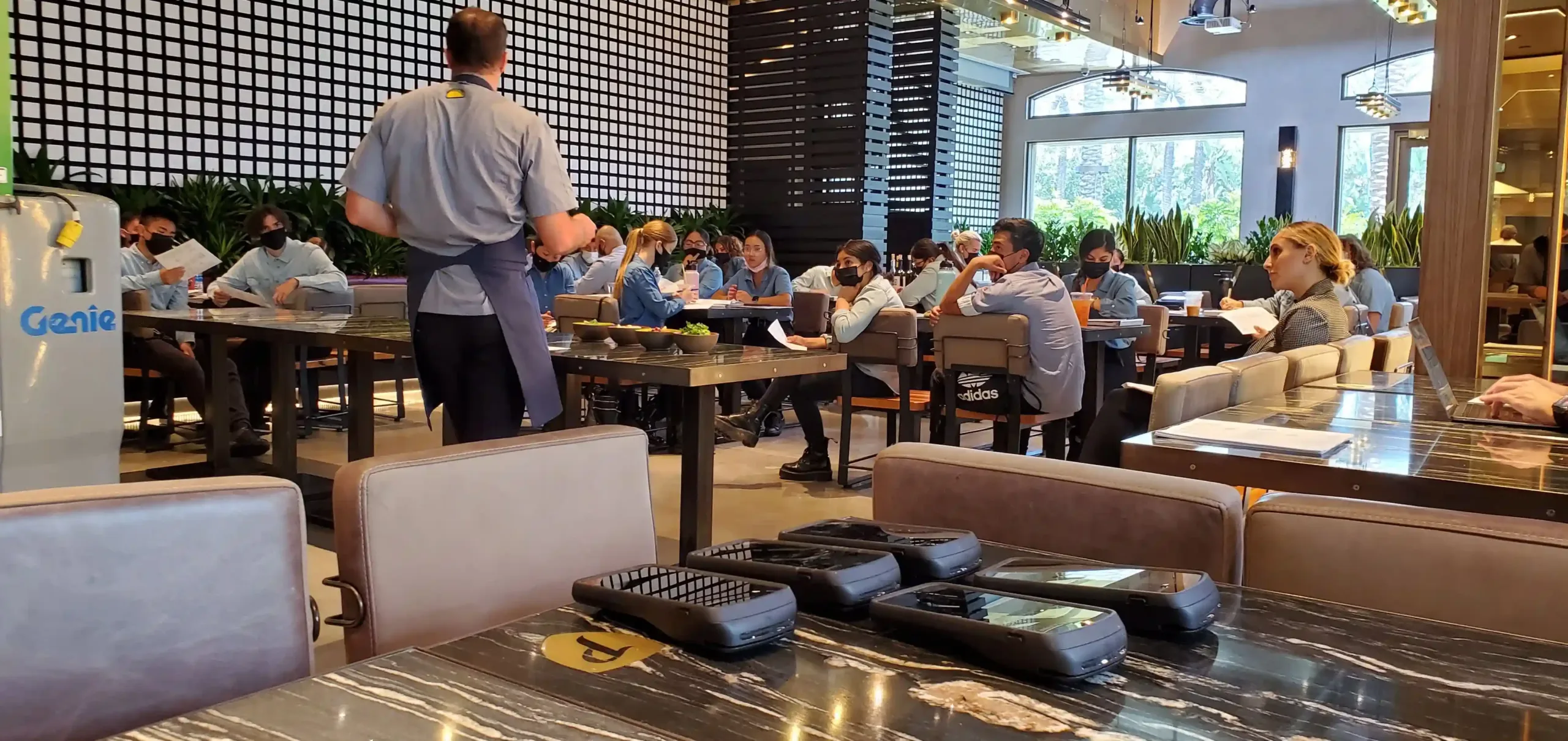 Sora Partners ensures a smooth transition: Technician trains employees on a new POS system after successful installation (providing ongoing support).