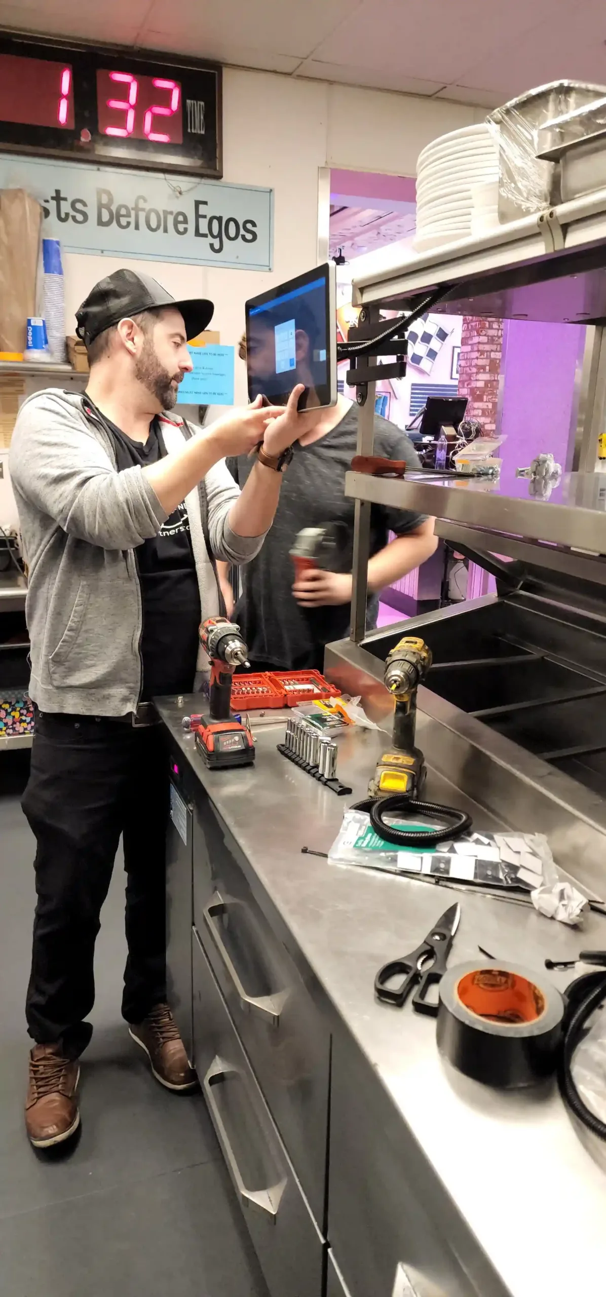 Our technicians installing a Kitchen Display System (KDS) to improve order communication for a customer's restaurant.